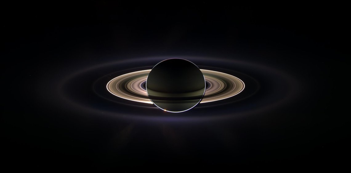This image provided by NASA Thursday Nov. 2, 2006 is a recent photo from the Cassini spacecraft showing the mighty planet Saturn, and if you look very closely between its wing-like rings, upper left, revelas a faint pinprick of light. That tiny dot is Earth bustling with life as we know it. The image is the second ever taken of our world from deep space. The first was captured by the Voyager spacecraft in 1990. This marvelous panoramic view was created by combining a total of 165 images taken by the Cassini wide-angle camera over nearly three hours on Sept. 15, 2006. The mosaic images were acquired as the spacecraft drifted in the darkness of Saturn's shadow for about 12 hours, allowing a multitude of unique observations of the microscopic particles that compose Saturn's faint rings. (AP Photo/NASA/JPL) This image provided by NASA Thursday Nov. 2, 2006 is a recent photo from the Cassini spacecraft showing the mighty planet Saturn, and if you look very closely between its wing-like rings, upper left, revelas a faint pinprick of light. That tiny dot is Earth bustling with life as we know it. The image is the second ever taken of our world from deep space. The first was captured by the Voyager spacecraft in 1990. This marvelous panoramic view was created by combining a total of 165 images taken by the Cassini wide-angle camera over nearly three hours on Sept. 15, 2006. The mosaic images were acquired as the spacecraft drifted in the darkness of Saturn's shadow for about 12 hours, allowing a multitude of unique observations of the microscopic particles that compose Saturn's faint rings. (AP Photo/NASA/JPL)