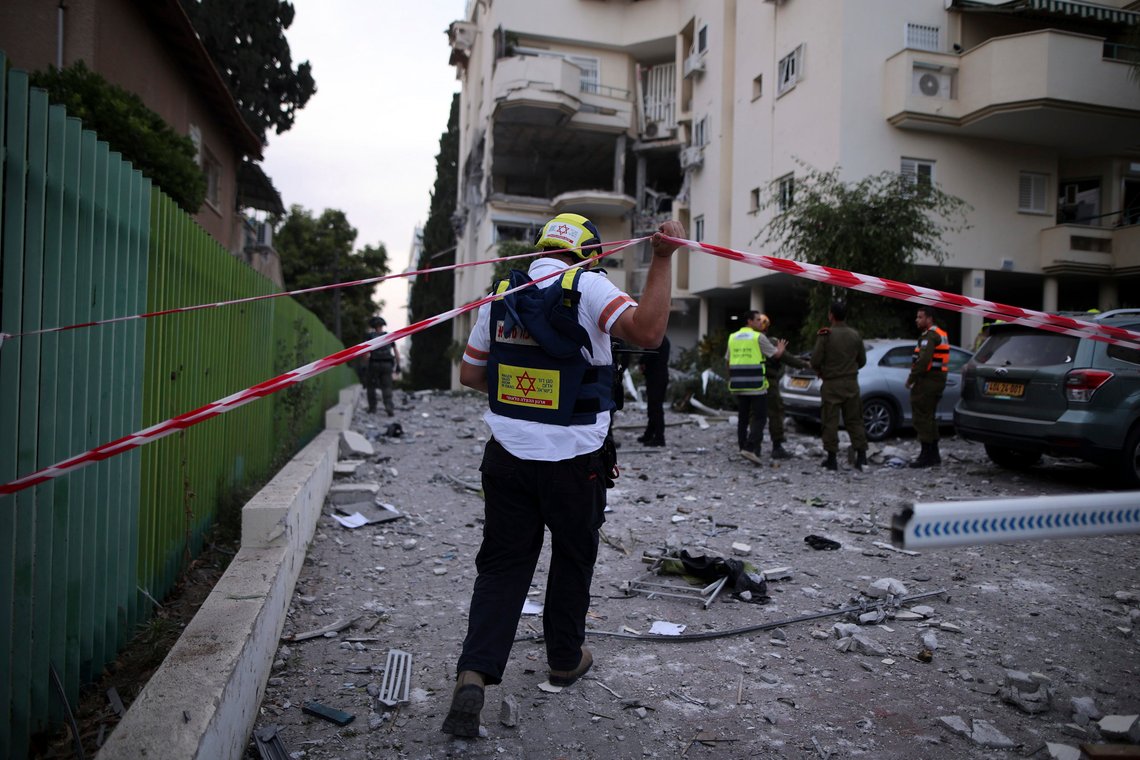 Israeli rescue workers inspect a damaged house after it was hit by a rocket fired from the Gaza Strip, in Rehovot, Israel, Wednesday, May 10, 2023. Israeli medics say a man is killed in a Palestinian rocket strike, the first fatality of the current fighting. (AP Photo/Ilan Assayag) Israeli rescue workers inspect a damaged house after it was hit by a rocket fired from the Gaza Strip, in Rehovot, Israel, Wednesday, May 10, 2023. Israeli medics say a man is killed in a Palestinian rocket strike, the first fatality of the current fighting. (AP Photo/Ilan Assayag)