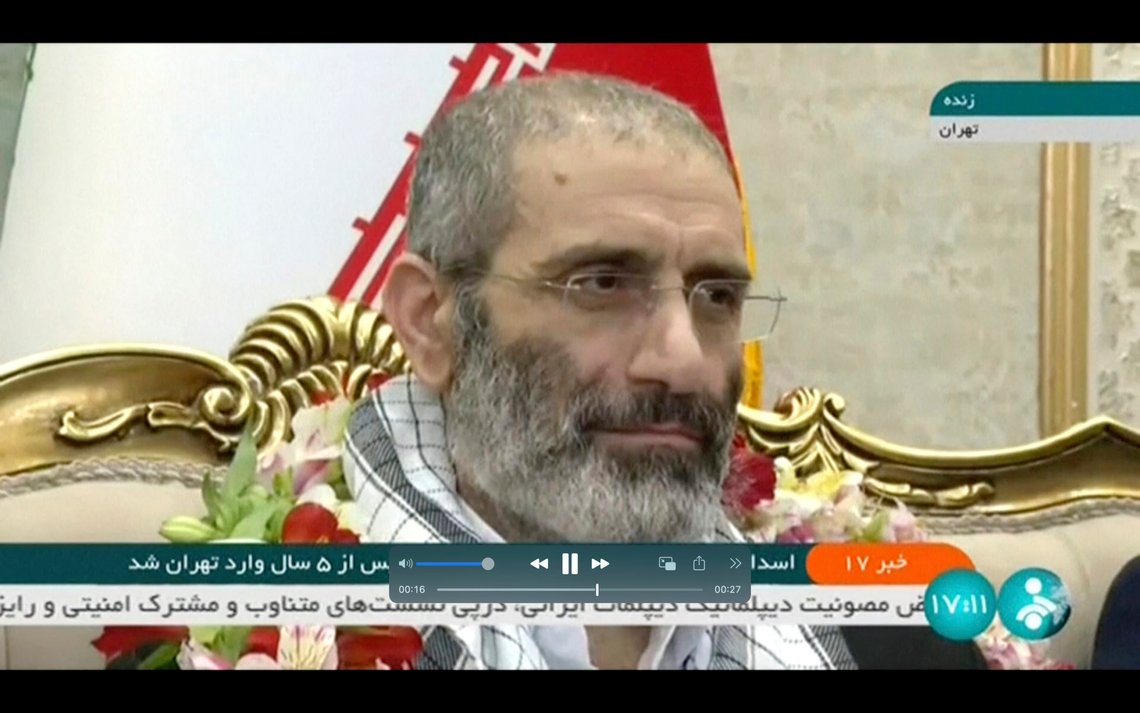 In this frame grab from video footage released Friday, May 26, 2023, by Iran state TV, IRINN, Assadollah Assadi, an Iranian diplomat who was released in a prisoner swap with Belgium, sits upon arrival at the Mehrabad airport in Tehran, Iran. Belgium and Iran exchanged prisoners on Friday in a controversial move that saw an Iranian diplomat convicted of attempting to bomb exiles in France bedecked in flowers on his return to Tehran while an aid worker was heading back to Brussels. (IRINN via AP) In this frame grab from video footage released Friday, May 26, 2023, by Iran state TV, IRINN, Assadollah Assadi, an Iranian diplomat who was released in a prisoner swap with Belgium, sits upon arrival at the Mehrabad airport in Tehran, Iran. Belgium and Iran exchanged prisoners on Friday in a controversial move that saw an Iranian diplomat convicted of attempting to bomb exiles in France bedecked in flowers on his return to Tehran while an aid worker was heading back to Brussels. (IRINN via AP)