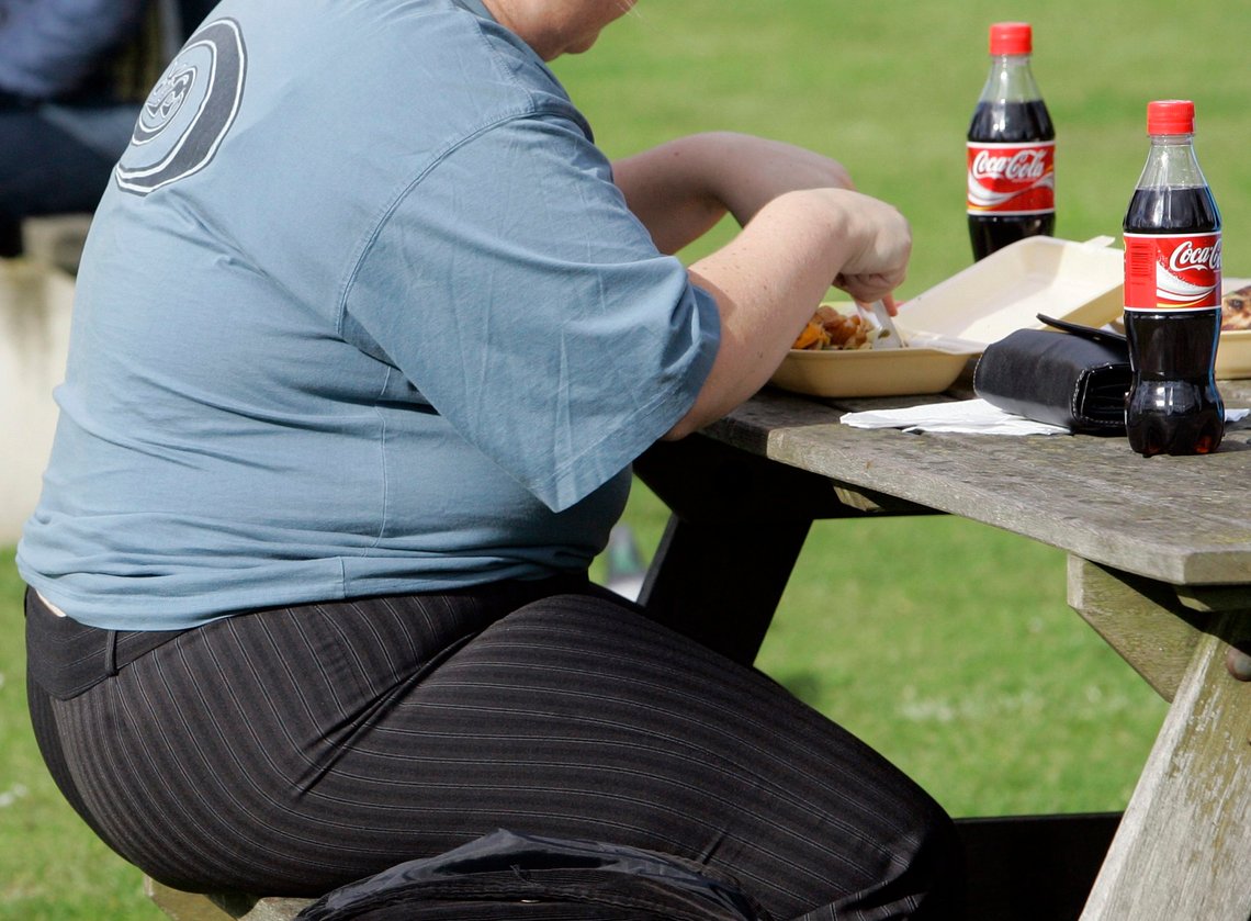 FILE- In this Wednesday, Oct. 17, 2007 file photo, an overweight person eats in London. The World Health Organization is taking on the battle of the bulge, saying that saturated fat shouldn't make up more than 10 percent of your diet. In its first draft guidelines on fat intake, the U.N. health agency said that to avoid piling on the pounds, both adults and children should ensure that no more than 10 percent of their calories should come from saturated fat, found in foods including butter, milk, meat, eggs and chocolate. (AP Photo/Kirsty Wigglesworth, file) FILE- In this Wednesday, Oct. 17, 2007 file photo, an overweight person eats in London. The World Health Organization is taking on the battle of the bulge, saying that saturated fat shouldn't make up more than 10 percent of your diet. In its first draft guidelines on fat intake, the U.N. health agency said that to avoid piling on the pounds, both adults and children should ensure that no more than 10 percent of their calories should come from saturated fat, found in foods including butter, milk, meat, eggs and chocolate. (AP Photo/Kirsty Wigglesworth, file)