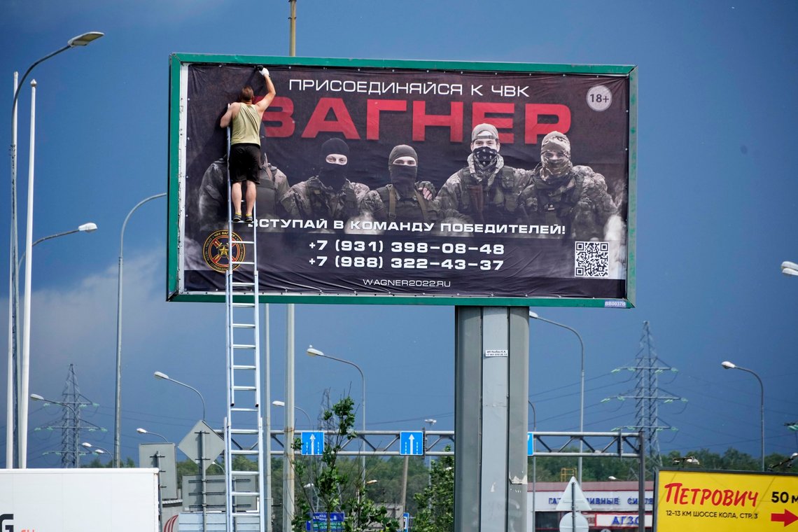 A man prepares to take down a poster reading "Join us at Wagner", which is associated with the owner of the Wagner private military contractor, Yevgeny Prigozhin, along a highway on the outskirts of St. Petersburg, Russia, Saturday, June 24, 2023. Russia's security services have responded to mercenary chief Prigozhin's declaration of an armed rebellion by calling for his arrest. In a sign of how seriously the Kremlin took the threat, security was heightened in Moscow, Rostov-on-Don and other regions. (AP Photo) A man prepares to take down a poster reading "Join us at Wagner", which is associated with the owner of the Wagner private military contractor, Yevgeny Prigozhin, along a highway on the outskirts of St. Petersburg, Russia, Saturday, June 24, 2023. Russia's security services have responded to mercenary chief Prigozhin's declaration of an armed rebellion by calling for his arrest. In a sign of how seriously the Kremlin took the threat, security was heightened in Moscow, Rostov-on-Don and other regions. (AP Photo)