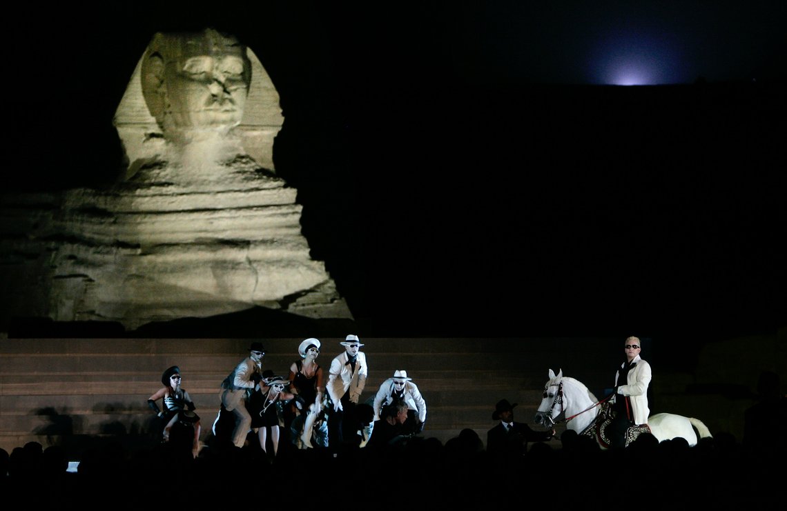 A performance of Henrik Ibsen's drama "Peer Gynt", attended by Queen Sonja of Norway and Suzanne Mubarak, wife of the Egyptian president, takes place at the Giza pyramids in Cairo, Egypt Friday, Oct. 27, 2006. "Peer Gynt" is Norwegian playwright Henrik Ibsen's imaginative version of the old "Play about Everyman" - a universal drama about the greatness of man, his fall, and restitution, and the production is the largest cultural cooperation between Norway and Egypt. (AP Photo/Ben Curtis, Pool) A performance of Henrik Ibsen's drama "Peer Gynt", attended by Queen Sonja of Norway and Suzanne Mubarak, wife of the Egyptian president, takes place at the Giza pyramids in Cairo, Egypt Friday, Oct. 27, 2006. "Peer Gynt" is Norwegian playwright Henrik Ibsen's imaginative version of the old "Play about Everyman" - a universal drama about the greatness of man, his fall, and restitution, and the production is the largest cultural cooperation between Norway and Egypt. (AP Photo/Ben Curtis, Pool)