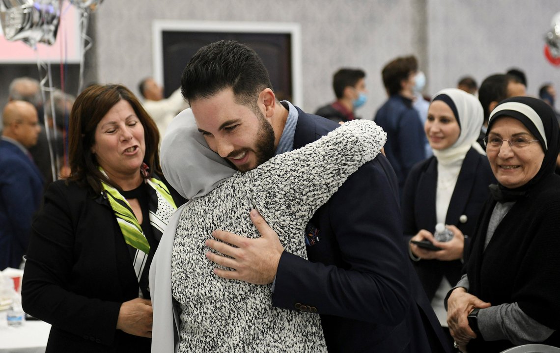 Dearborn mayor candidate Abdullah Hammoud hugs family member Taghrid Beydoun of Dearborn Heights, as other family members Hiyam Makki, left, and Sue Beydoun, far right, stand by at the Mohammed Turfe Community Center in Dearborn, Mich., on Tuesday, Nov. 2, 2021. Hammoud, a Michigan state lawmaker has won the Dearborn mayoral race, making him that city’s first Arab American mayor. (Robin Buckson /Detroit News via AP) Dearborn mayor candidate Abdullah Hammoud hugs family member Taghrid Beydoun of Dearborn Heights, as other family members Hiyam Makki, left, and Sue Beydoun, far right, stand by at the Mohammed Turfe Community Center in Dearborn, Mich., on Tuesday, Nov. 2, 2021. Hammoud, a Michigan state lawmaker has won the Dearborn mayoral race, making him that city’s first Arab American mayor. (Robin Buckson /Detroit News via AP)