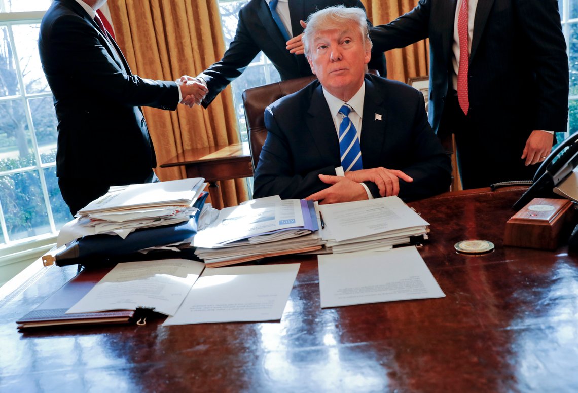 FILE - President Donald Trump sits at his desk after a meeting with Intel CEO Brian Krzanich, left, and members of his staff in the Oval Office of the White House in Washington, Feb. 8, 2017, as a lockbag is visible on the desk, the key still inside at left. (AP Photo/Pablo Martinez Monsivais, File) FILE - President Donald Trump sits at his desk after a meeting with Intel CEO Brian Krzanich, left, and members of his staff in the Oval Office of the White House in Washington, Feb. 8, 2017, as a lockbag is visible on the desk, the key still inside at left. (AP Photo/Pablo Martinez Monsivais, File)