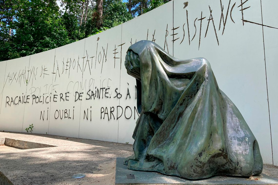 A graffiti reading "Police scum from Saint-Soline to Nanterre - do not forget or forgive" on a monument commemorating Holocaust victims and members of the French resistance memorial, Sunday, July 2, 2023 in Paris suburb Nanterre. In Nanterre, a monument commemorating Holocaust victims and members of the French resistance during World War II was defaced with graffiti Sunday, after it has been vandalized Thursday on the margins of a silent march to pay tribute after the police killing of a teenager. (AP Photo/Cara Anna) A graffiti reading "Police scum from Saint-Soline to Nanterre - do not forget or forgive" on a monument commemorating Holocaust victims and members of the French resistance memorial, Sunday, July 2, 2023 in Paris suburb Nanterre. In Nanterre, a monument commemorating Holocaust victims and members of the French resistance during World War II was defaced with graffiti Sunday, after it has been vandalized Thursday on the margins of a silent march to pay tribute after the police killing of a teenager. (AP Photo/Cara Anna)