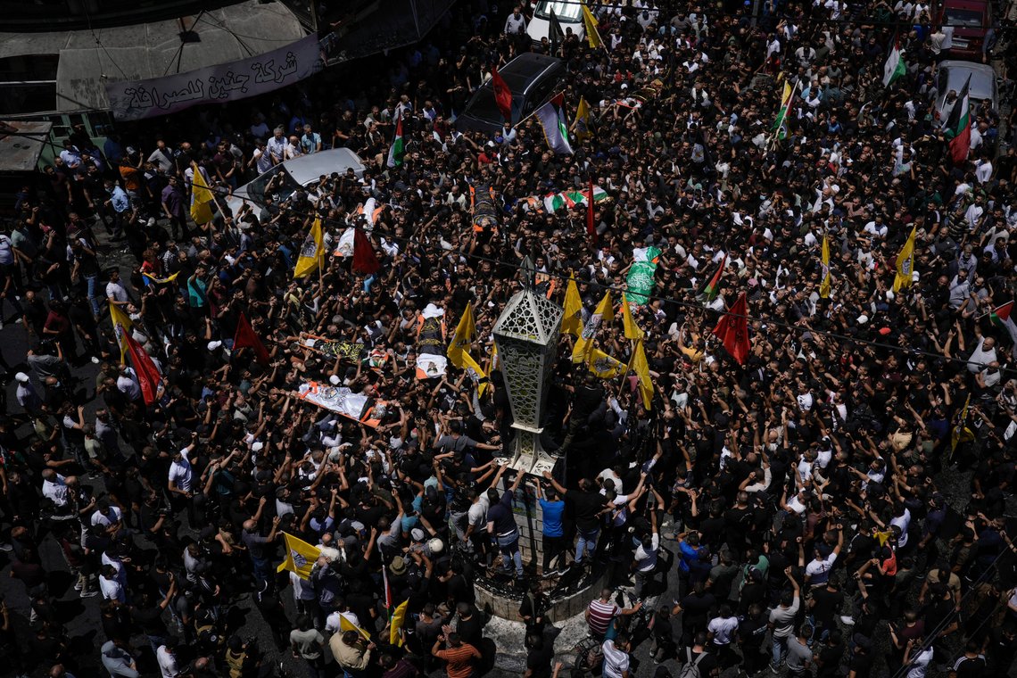 Mourners carry the bodies of Palestinian men, some draped in the flags of the Islamic Jihad militant group and Hamas, during their funeral, in the Jenin refugee camp, West Bank, Wednesday, July 5, 2023. The Israeli military says it withdrew its troops from the camp on Wednesday, ending an intense two-day operation that killed at least 13 Palestinians, drove thousands of people from their homes and left a wide swath of damage in its wake. One Israeli soldier was also killed. (AP Photo/Majdi Mohammed) Mourners carry the bodies of Palestinian men, some draped in the flags of the Islamic Jihad militant group and Hamas, during their funeral, in the Jenin refugee camp, West Bank, Wednesday, July 5, 2023. The Israeli military says it withdrew its troops from the camp on Wednesday, ending an intense two-day operation that killed at least 13 Palestinians, drove thousands of people from their homes and left a wide swath of damage in its wake. One Israeli soldier was also killed. (AP Photo/Majdi Mohammed)