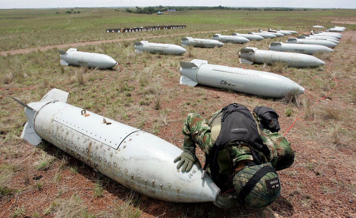 An explosive expert of Colombia's Air Force defuses a cluster bomb prior to its destruction at a military base in Marandua, in southern Colombia, Thursday, May 7, 2009. About forty cluster bombs were destroyed as part of an agreement to ban the use of this type of bombs signed by Colombia in Oslo in 2008. (AP Photo/Fernando Vergara) An explosive expert of Colombia's Air Force defuses a cluster bomb prior to its destruction at a military base in Marandua, in southern Colombia, Thursday, May 7, 2009. About forty cluster bombs were destroyed as part of an agreement to ban the use of this type of bombs signed by Colombia in Oslo in 2008. (AP Photo/Fernando Vergara)