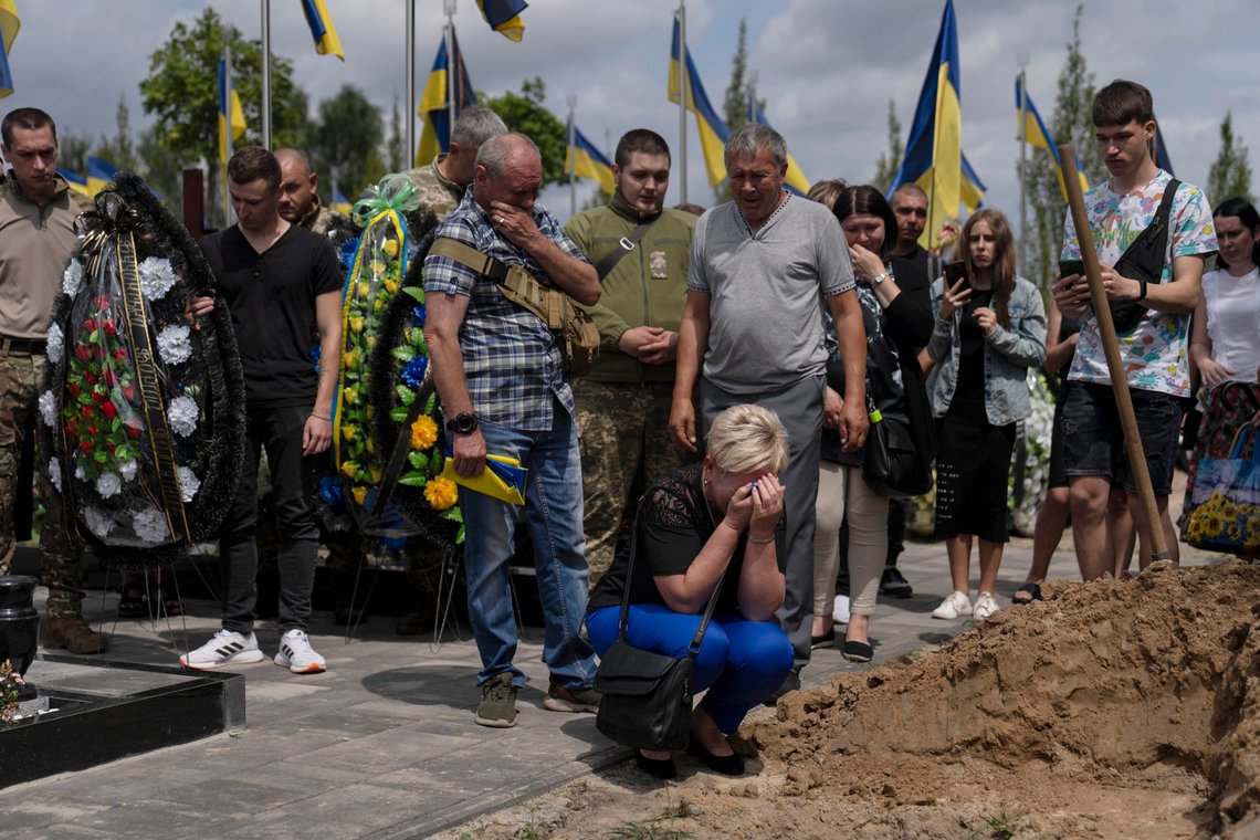A woman mourns at the grave of Roman Shadlovskyi during a reburial service for him in Bucha, Ukraine, Tuesday, July 18, 2023. The Ukrainian Armed Forces veteran, who was initially buried in a mass grave as an unidentified victim after being killed last year by Russian troops, received a reburial Tuesday after a DNA test confirmed his identity. (AP Photo/Jae C. Hong) A woman mourns at the grave of Roman Shadlovskyi during a reburial service for him in Bucha, Ukraine, Tuesday, July 18, 2023. The Ukrainian Armed Forces veteran, who was initially buried in a mass grave as an unidentified victim after being killed last year by Russian troops, received a reburial Tuesday after a DNA test confirmed his identity. (AP Photo/Jae C. Hong)
