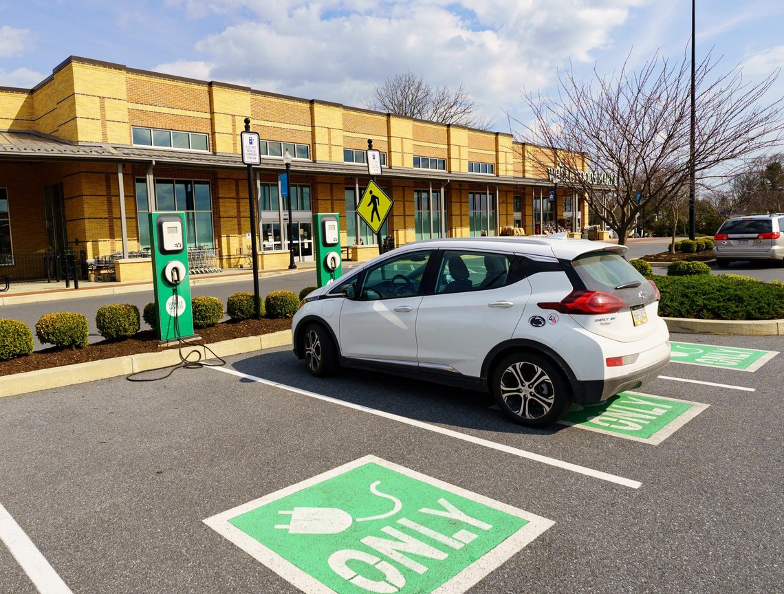 Lancaster, PA, USA - March 18, 2022: An EV charging station in the parking lot of a grocery store allows costumes to recharge their eclectic car while shopping. Photo: Shutterstock by George Sheldon. Lancaster, PA, USA - March 18, 2022: An EV charging station in the parking lot of a grocery store allows costumes to recharge their eclectic car while shopping. Photo: Shutterstock by George Sheldon.
