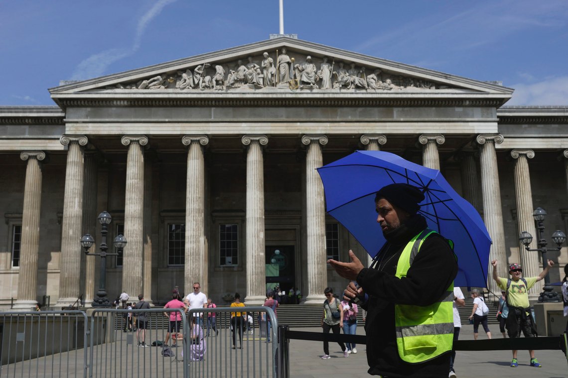 A worker holding an umbrella guides the tourists at British Museum during a hot weather day in Central London, Monday, June 12, 2023. (AP Photo/Kin Cheung) A worker holding an umbrella guides the tourists at British Museum during a hot weather day in Central London, Monday, June 12, 2023. (AP Photo/Kin Cheung)