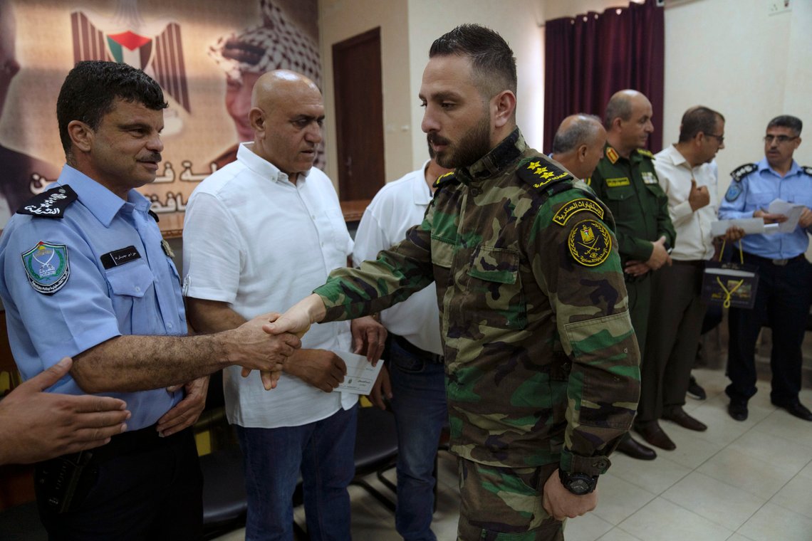 Jenin's police commander Brig. Gen. Azzam Jebara, left, decorates Palestinian security officers, who responded to an arson attack by angry protesters on the Jaba police station in July, at the governorate headquarters of the West Bank city of Jenin, Sunday, Aug. 13, 2023. (AP Photo/Nasser Nasser) Jenin's police commander Brig. Gen. Azzam Jebara, left, decorates Palestinian security officers, who responded to an arson attack by angry protesters on the Jaba police station in July, at the governorate headquarters of the West Bank city of Jenin, Sunday, Aug. 13, 2023. (AP Photo/Nasser Nasser)