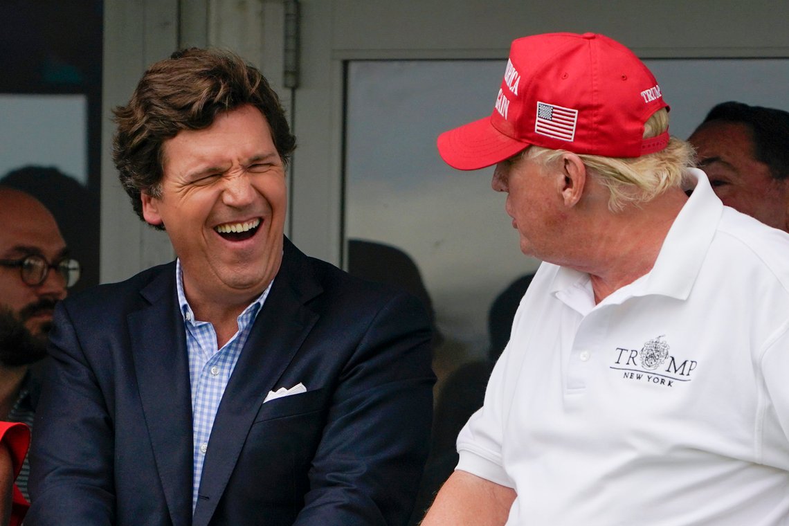 FILE - Tucker Carlson, left, and former President Donald Trump, right, react during the final round of the Bedminster Invitational LIV Golf tournament in Bedminster, N.J., July 31, 2022. A defamation lawsuit against Fox News is revealing blunt behind-the-scenes opinions by its top figures about Donald Trump, including a Tucker Carlson text message where he said “I hate him passionately.” Carlson's private conversation was revealed in court papers at virtually the same time as the former president was hailing the Fox News host on social media for a “great job” for using U.S. Capitol security video to produce a false narrative of the Jan. 6, 2021, insurrection. (AP Photo/Seth Wenig, File) FILE - Tucker Carlson, left, and former President Donald Trump, right, react during the final round of the Bedminster Invitational LIV Golf tournament in Bedminster, N.J., July 31, 2022. A defamation lawsuit against Fox News is revealing blunt behind-the-scenes opinions by its top figures about Donald Trump, including a Tucker Carlson text message where he said “I hate him passionately.” Carlson's private conversation was revealed in court papers at virtually the same time as the former president was hailing the Fox News host on social media for a “great job” for using U.S. Capitol security video to produce a false narrative of the Jan. 6, 2021, insurrection. (AP Photo/Seth Wenig, File)