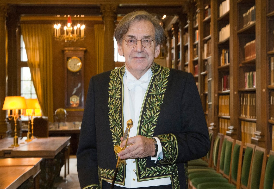 FILE - In this Jan.28, 2016 file photo, French philosopher Alain Finkielkraut, wearing the French Academician's outfit, displays his ceremonial epee in the library of the Institut de France before a ceremony in Paris. Paris officials say that an individual has been arrested for a torrent of hate speech directed at Jewish philosopher Alain Finkielkraut during a Saturday march by yellow vest protesters. (AP Photo/Jacques Brinon, File) FILE - In this Jan.28, 2016 file photo, French philosopher Alain Finkielkraut, wearing the French Academician's outfit, displays his ceremonial epee in the library of the Institut de France before a ceremony in Paris. Paris officials say that an individual has been arrested for a torrent of hate speech directed at Jewish philosopher Alain Finkielkraut during a Saturday march by yellow vest protesters. (AP Photo/Jacques Brinon, File)