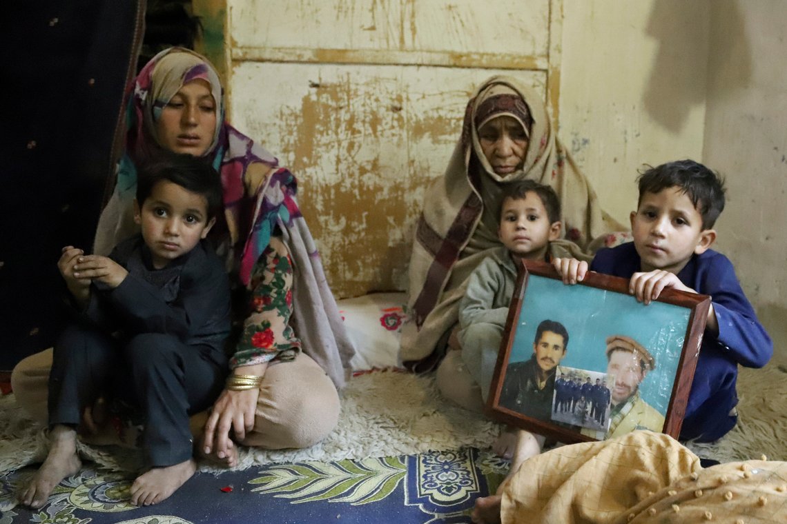 A son of Mohammed Hassan, a Pakistani porter who died on July 27 during a summit of K2, holds a portrait of his father and grandfather, with Hassan's mother, third left, and wife at their home in Tasar, a village in the Shigar district in the Gilgit-Baltistan region of northern Pakistan, Saturday, Aug. 12, 2023. An investigation has been launched into the death of a Hassan near the peak of the world's most treacherous mountain, a Pakistani mountaineer said Saturday, following allegations that dozens of climbers eager to reach the summit had walked past the man after he was gravely injured in a fall. (AP Photo/M.H. Balti) A son of Mohammed Hassan, a Pakistani porter who died on July 27 during a summit of K2, holds a portrait of his father and grandfather, with Hassan's mother, third left, and wife at their home in Tasar, a village in the Shigar district in the Gilgit-Baltistan region of northern Pakistan, Saturday, Aug. 12, 2023. An investigation has been launched into the death of a Hassan near the peak of the world's most treacherous mountain, a Pakistani mountaineer said Saturday, following allegations that dozens of climbers eager to reach the summit had walked past the man after he was gravely injured in a fall. (AP Photo/M.H. Balti)