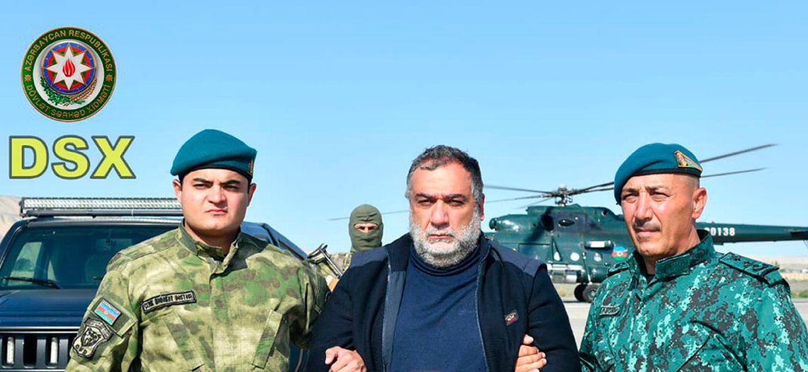 In this photo released by Azerbaijan's border guard service on Wednesday, Sept. 27, 2023, Azerbaijan's border guard officers pose with detained Ruben Vardanyan, center, in Nagorno-Karabakh. Azerbaijan says it has detained the former head of Nagorno-Karabakh's separatist government as he tried to cross into Armenia following Azerbaijan's 24-hour blitz last week to reclaim control of the enclave. The arrest of Ruben Vardanyan was announced by Azerbaijan's border guard service. (Azerbaijan's border guard service via AP) In this photo released by Azerbaijan's border guard service on Wednesday, Sept. 27, 2023, Azerbaijan's border guard officers pose with detained Ruben Vardanyan, center, in Nagorno-Karabakh. Azerbaijan says it has detained the former head of Nagorno-Karabakh's separatist government as he tried to cross into Armenia following Azerbaijan's 24-hour blitz last week to reclaim control of the enclave. The arrest of Ruben Vardanyan was announced by Azerbaijan's border guard service. (Azerbaijan's border guard service via AP)