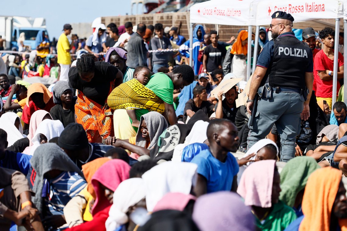Migrants wait to be transferred from the Lampedusa Island to the mainland, Friday, Sept. 15, 2023. Thousands of migrants and refugees have landed on the Italian island of Lampedusa this week after crossing the Mediterranean Sea on small unseaworthy boats from Tunisia, overwhelming local authorities and aid organizations . (Cecilia Fabiano/LaPresse via AP) Migrants wait to be transferred from the Lampedusa Island to the mainland, Friday, Sept. 15, 2023. Thousands of migrants and refugees have landed on the Italian island of Lampedusa this week after crossing the Mediterranean Sea on small unseaworthy boats from Tunisia, overwhelming local authorities and aid organizations . (Cecilia Fabiano/LaPresse via AP)