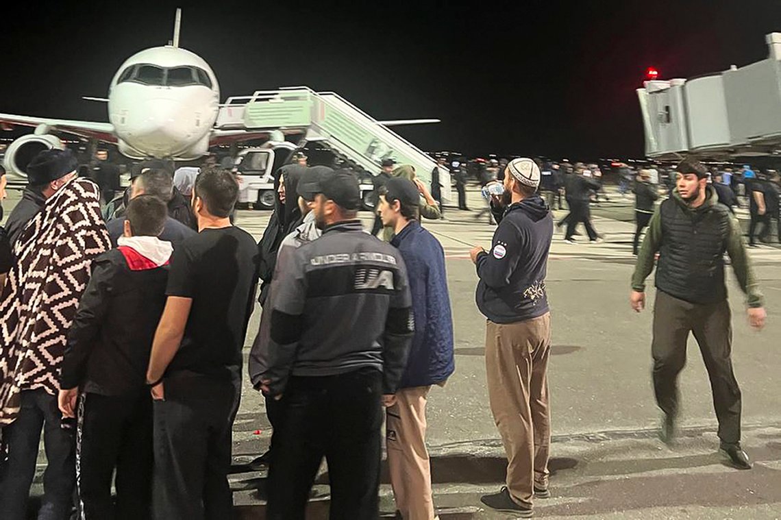 People in the crowd walk shouting antisemitic slogans at an airfield of the airport in Makhachkala, Russia, Monday, Oct. 30, 2023. Russian news agencies and social media say hundreds of people have stormed into the main airport in the Dagestan region and onto the landing field to protest the arrival of an airliner coming from Tel Aviv, Israel. (AP Photo) People in the crowd walk shouting antisemitic slogans at an airfield of the airport in Makhachkala, Russia, Monday, Oct. 30, 2023. Russian news agencies and social media say hundreds of people have stormed into the main airport in the Dagestan region and onto the landing field to protest the arrival of an airliner coming from Tel Aviv, Israel. (AP Photo)
