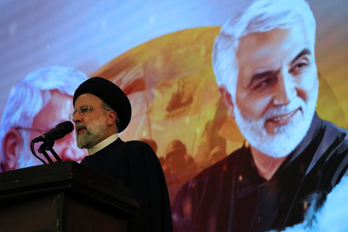 Iranian President Ebrahim Raisi addresses a ceremony marking anniversary of the death of the late Revolutionary Guard Gen. Qassem Soleimani, shown in the poster in background, who was killed in Iraq in a U.S. drone attack in 2020, at Imam Khomeini Grand Mosque in Tehran, Iran, Tuesday, Jan. 3, 2023. President Raisi vowed to avenge the killing of the country's top general, as the government rallied its supporters in mourning amid months of anti-government protests. (AP Photo/Vahid Salemi) Iranian President Ebrahim Raisi addresses a ceremony marking anniversary of the death of the late Revolutionary Guard Gen. Qassem Soleimani, shown in the poster in background, who was killed in Iraq in a U.S. drone attack in 2020, at Imam Khomeini Grand Mosque in Tehran, Iran, Tuesday, Jan. 3, 2023. President Raisi vowed to avenge the killing of the country's top general, as the government rallied its supporters in mourning amid months of anti-government protests. (AP Photo/Vahid Salemi)
