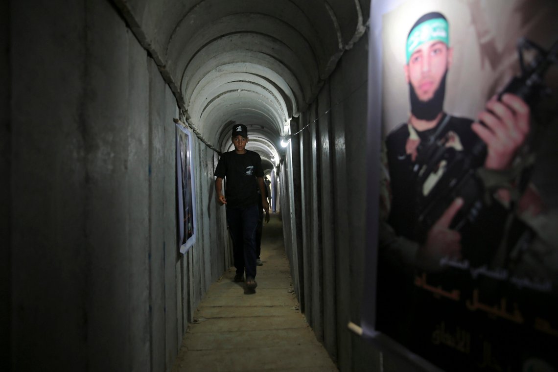 FILE - A Palestinian youth walks inside a tunnel used for military exercises during a weapon exhibition at a Hamas-run youth summer camp in Gaza City July 20, 2016. An extensive labyrinth of tunnels built by Hamas stretches across the dense neighborhoods of the Gaza Strip, hiding militants, their missile arsenal and the over 200 hostages they now hold after an unprecedented Oct. 7, 2023, attack on Israel. (AP Photo/Adel Hana, File) FILE - A Palestinian youth walks inside a tunnel used for military exercises during a weapon exhibition at a Hamas-run youth summer camp in Gaza City July 20, 2016. An extensive labyrinth of tunnels built by Hamas stretches across the dense neighborhoods of the Gaza Strip, hiding militants, their missile arsenal and the over 200 hostages they now hold after an unprecedented Oct. 7, 2023, attack on Israel. (AP Photo/Adel Hana, File)