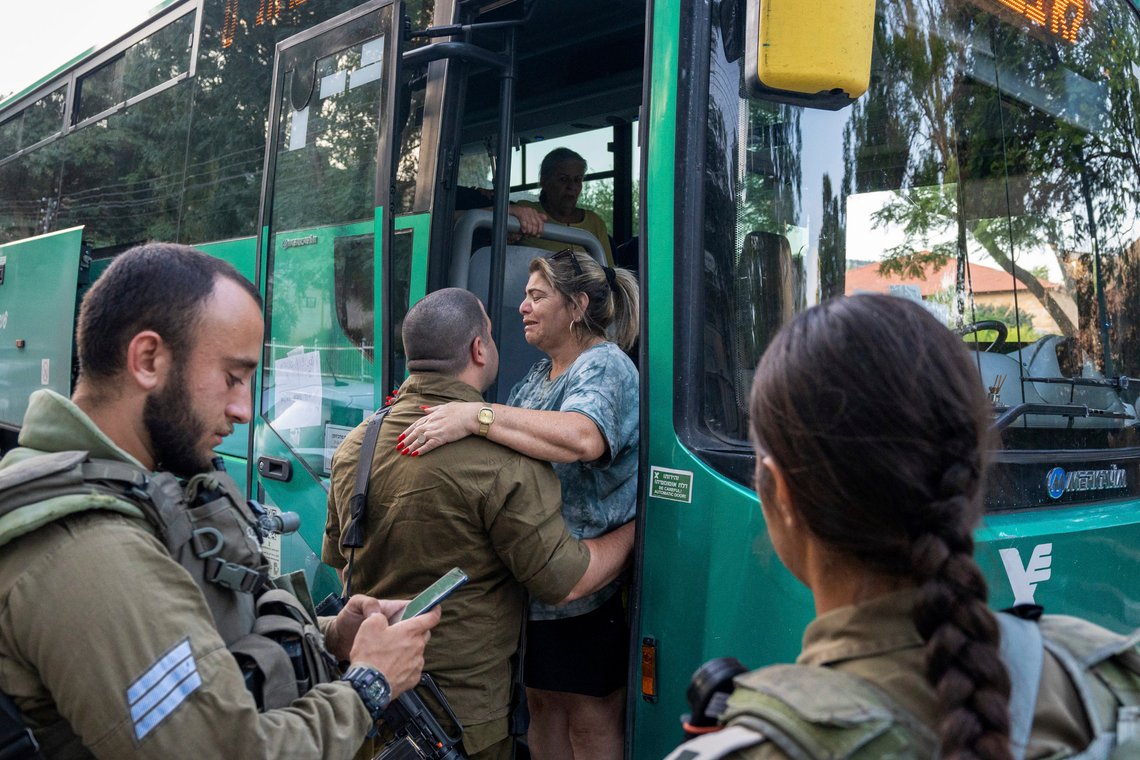 Israeli soldiers help a woman as she gets on a bus to evacuate from the northern Israeli city of Kiryat Shmona, Israel, Friday, Oct. 20, 2023. The Israeli military announced Friday it would evacuate the border city a day after three residents were injured by cross-border fire from militants in Lebanon. (AP Photo/Baz Ratner) Israeli soldiers help a woman as she gets on a bus to evacuate from the northern Israeli city of Kiryat Shmona, Israel, Friday, Oct. 20, 2023. The Israeli military announced Friday it would evacuate the border city a day after three residents were injured by cross-border fire from militants in Lebanon. (AP Photo/Baz Ratner)