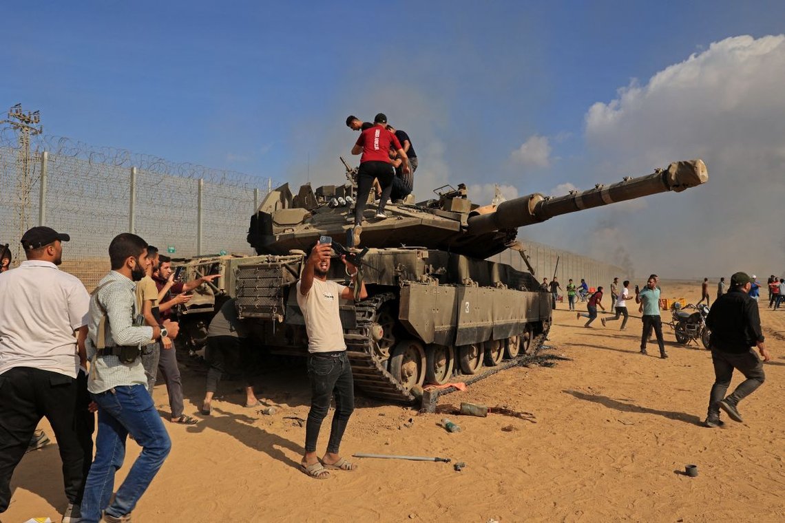 Photo: October 7, 2023. Palestinians celebrating the capture of a tank. Wikimedia. Aljazeera. Photo: October 7, 2023. Palestinians celebrating the capture of a tank. Wikimedia. Aljazeera.