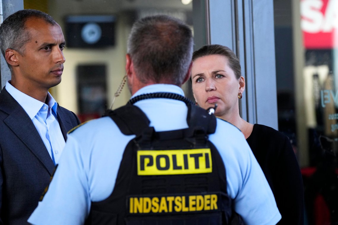 Danish Prime Minister Mette Frederiksen, right, and Minister of Justice Mattias Tesfaye, left, listen to a police officer as they come to lay flowers at the entrance of the Field's shopping center in Copenhagen, Denmark, Monday, July 4, 2022. Danish police believe a shopping mall shooting that left three people dead and four others seriously wounded was not terror-related. They said Monday that the gunman acted alone and appears to have selected his victims at random. (AP Photo/Sergei Grits) Danish Prime Minister Mette Frederiksen, right, and Minister of Justice Mattias Tesfaye, left, listen to a police officer as they come to lay flowers at the entrance of the Field's shopping center in Copenhagen, Denmark, Monday, July 4, 2022. Danish police believe a shopping mall shooting that left three people dead and four others seriously wounded was not terror-related. They said Monday that the gunman acted alone and appears to have selected his victims at random. (AP Photo/Sergei Grits)