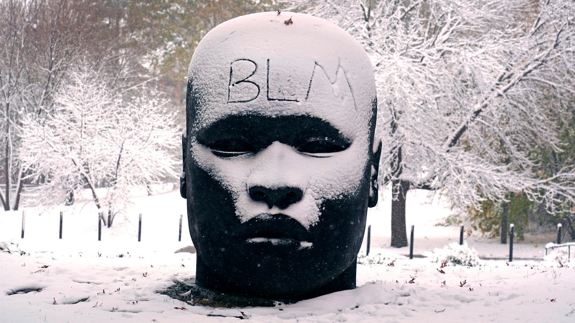 The abbreviation "BLM", for the Black Lives Matter movement, written on the forehead of the "Eternal Presence" statue outside the National Center of Afro-American Artists, Friday, Oct. 30, 2020, in the Roxbury neighborhood of Boston. The Boston area was blanketed with a few inches of snow during the day. (AP Photo/Charles Krupa) The abbreviation "BLM", for the Black Lives Matter movement, written on the forehead of the "Eternal Presence" statue outside the National Center of Afro-American Artists, Friday, Oct. 30, 2020, in the Roxbury neighborhood of Boston. The Boston area was blanketed with a few inches of snow during the day. (AP Photo/Charles Krupa)