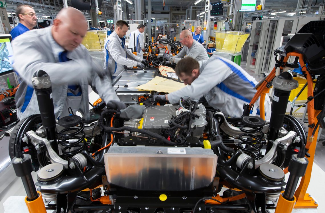 FILE - Workers complete an electric car ID.3 body at the assembly line during a press tour at the plant of the German manufacturer Volkswagen AG (VW) in Zwickau, Germany, Tuesday, Feb. 25. 2020. Germany's transport minister said Thursday that he opposes plans to ban the sale of new cars with combustion engines across the European Union in 2035, arguing this would discriminate against vehicles powered with synthetic fuels. EU lawmakers voted Wednesday to back the measure that requires automakers to cut carbon-dioxide emissions by 100% by the middle of the next decade, effectively prohibiting the sale in the 27-nation bloc of new cars powered by gasoline or diesel. (AP Photo/Jens Meyer, file) FILE - Workers complete an electric car ID.3 body at the assembly line during a press tour at the plant of the German manufacturer Volkswagen AG (VW) in Zwickau, Germany, Tuesday, Feb. 25. 2020. Germany's transport minister said Thursday that he opposes plans to ban the sale of new cars with combustion engines across the European Union in 2035, arguing this would discriminate against vehicles powered with synthetic fuels. EU lawmakers voted Wednesday to back the measure that requires automakers to cut carbon-dioxide emissions by 100% by the middle of the next decade, effectively prohibiting the sale in the 27-nation bloc of new cars powered by gasoline or diesel. (AP Photo/Jens Meyer, file)