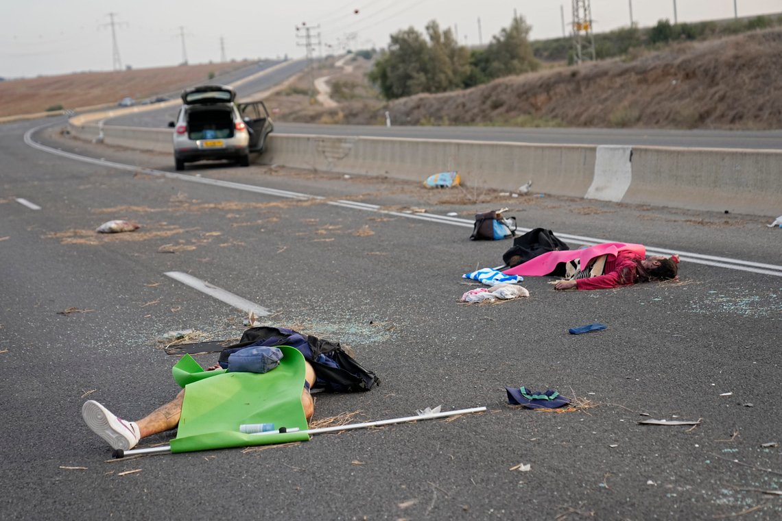 Israelis killed by Hamas militants lie on the road near Sderot, Israel, on Oct. 7, 2023. Palestinian militants from the Gaza Strip infiltrated southern Israel Saturday and fired thousands of rockets into the country, prompting Israel to begin striking targets in Gaza in response. (AP Photo/Ohad Zwigenberg) Israelis killed by Hamas militants lie on the road near Sderot, Israel, on Oct. 7, 2023. Palestinian militants from the Gaza Strip infiltrated southern Israel Saturday and fired thousands of rockets into the country, prompting Israel to begin striking targets in Gaza in response. (AP Photo/Ohad Zwigenberg)