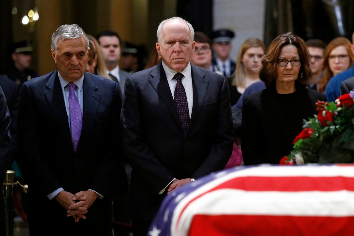 Former CIA directors George Tenet, left, and John Brennan pause alongside current director Gina Haspel in front of the flag-draped casket of former President George H.W. Bush as he lies in state in the Capitol Rotunda in Washington, Tuesday, Dec. 4, 2018. (AP Photo/Patrick Semansky) Former CIA directors George Tenet, left, and John Brennan pause alongside current director Gina Haspel in front of the flag-draped casket of former President George H.W. Bush as he lies in state in the Capitol Rotunda in Washington, Tuesday, Dec. 4, 2018. (AP Photo/Patrick Semansky)