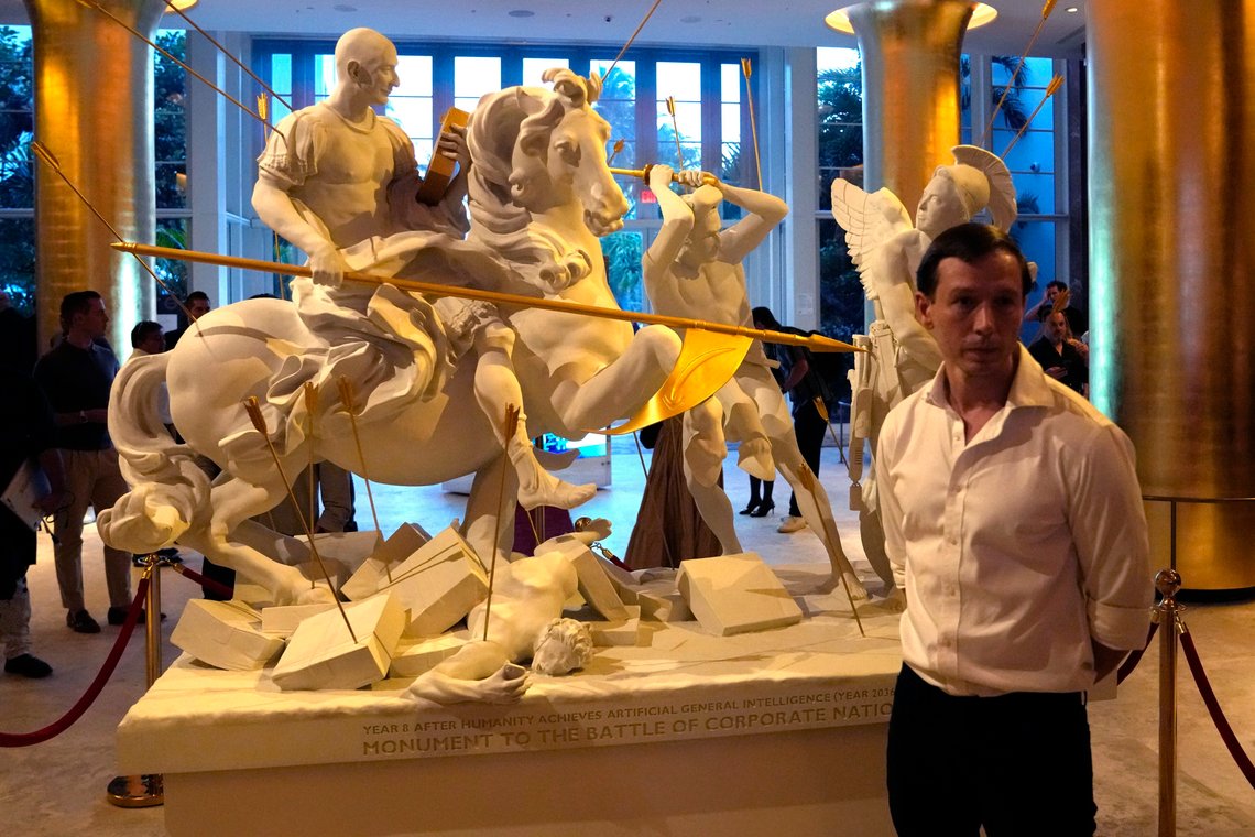 Chilean artist Sebastian Errazuriz stands with his sculpture titled "Battle of the Corporate Nations" at the Faena Hotel during Miami Art Week, Tuesday, Dec. 5, 2023, in Miami Beach, Fla. The piece depicts Jeff Bezos, left, Mark Zuckerberg, center, and Elon Musk, right. (AP Photo/Lynne Sladky) Chilean artist Sebastian Errazuriz stands with his sculpture titled "Battle of the Corporate Nations" at the Faena Hotel during Miami Art Week, Tuesday, Dec. 5, 2023, in Miami Beach, Fla. The piece depicts Jeff Bezos, left, Mark Zuckerberg, center, and Elon Musk, right. (AP Photo/Lynne Sladky)