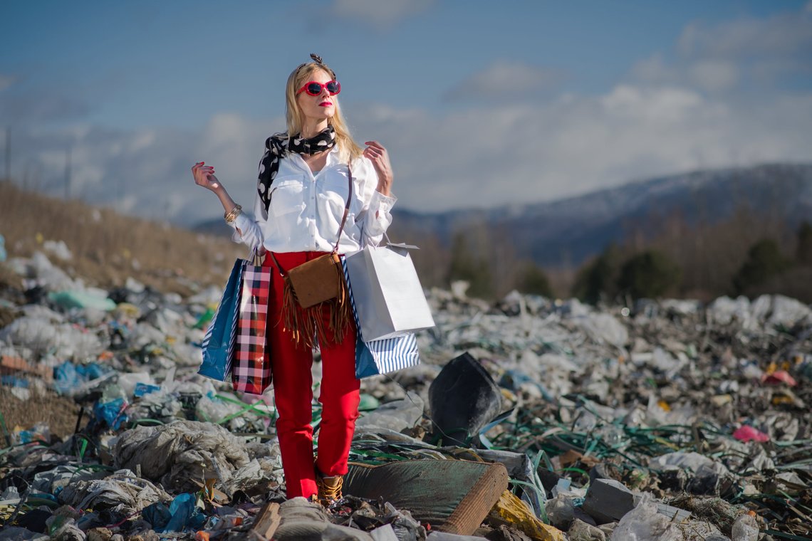 Modern woman on landfill, consumerism versus pollution concept. Photo: Shutterstock by Ground Picture. Modern woman on landfill, consumerism versus pollution concept. Photo: Shutterstock by Ground Picture.
