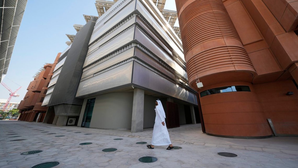 A man walks past a building with solar panels at Masdar City near Abu Dhabi, United Arab Emirates, as Dubai hosts the COP28 U.N. Climate Summit, Friday, Dec. 8, 2023. (AP Photo/Kamran Jebreili) A man walks past a building with solar panels at Masdar City near Abu Dhabi, United Arab Emirates, as Dubai hosts the COP28 U.N. Climate Summit, Friday, Dec. 8, 2023. (AP Photo/Kamran Jebreili)