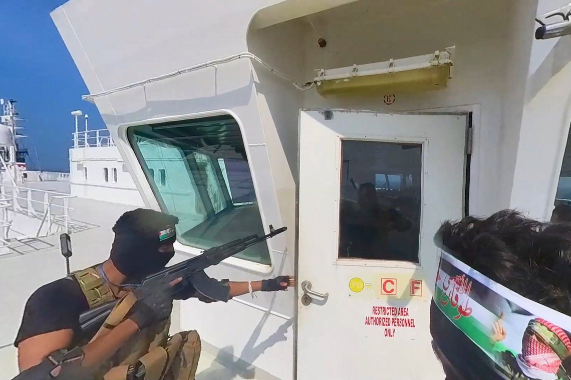 This photo released by the Houthi Media Center shows Houthi forces boarding the cargo ship Galaxy Leader on Sunday, Nov. 19, 2023. Yemen's Houthis have seized the ship in the Red Sea off the coast of Yemen after threatening to seize all vessels owned by Israeli companies. (Houthi Media Center via AP) This photo released by the Houthi Media Center shows Houthi forces boarding the cargo ship Galaxy Leader on Sunday, Nov. 19, 2023. Yemen's Houthis have seized the ship in the Red Sea off the coast of Yemen after threatening to seize all vessels owned by Israeli companies. (Houthi Media Center via AP)