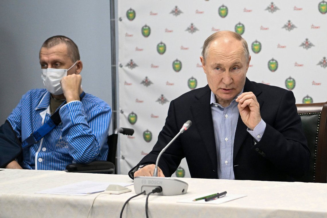 Russian President Vladimir Putin gestures speaking to Russian servicemen, participants of the special military operation in Ukraine undergoing treatment after injuries at the branch No. 2 of the National Medical Research Center for High Medical Technologies, the Central Military Clinical Hospital named after Alexander Vishnevsky of the Ministry of Defense of the Russian Federation in Moscow, Russia, Monday, Jan. 1, 2024. (Kristina Kormilitsyna, Sputnik, Kremlin Pool Photo via AP) Russian President Vladimir Putin gestures speaking to Russian servicemen, participants of the special military operation in Ukraine undergoing treatment after injuries at the branch No. 2 of the National Medical Research Center for High Medical Technologies, the Central Military Clinical Hospital named after Alexander Vishnevsky of the Ministry of Defense of the Russian Federation in Moscow, Russia, Monday, Jan. 1, 2024. (Kristina Kormilitsyna, Sputnik, Kremlin Pool Photo via AP)