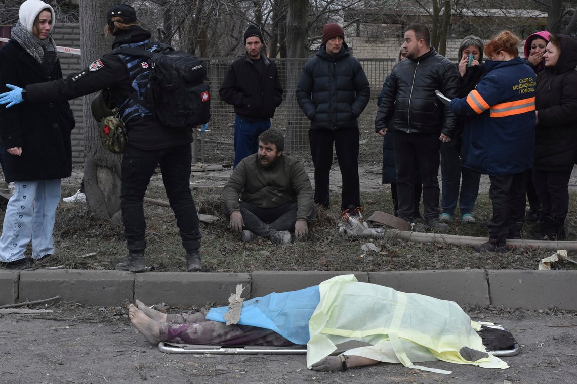 People react standing near the body of a resident, killed in Russia's massive air attack in Zaporizhzhia, Ukraine, Friday, Dec. 29, 2023. Russia launched missiles as well as drones against Ukrainian targets during the night Ukraine President Volodymyr Zelenskyy said Friday, killing a number of civilians in what appeared to be one of the biggest aerial barrages of the 22-month war. (AP Photo/Andriy Andriyenko) People react standing near the body of a resident, killed in Russia's massive air attack in Zaporizhzhia, Ukraine, Friday, Dec. 29, 2023. Russia launched missiles as well as drones against Ukrainian targets during the night Ukraine President Volodymyr Zelenskyy said Friday, killing a number of civilians in what appeared to be one of the biggest aerial barrages of the 22-month war. (AP Photo/Andriy Andriyenko)