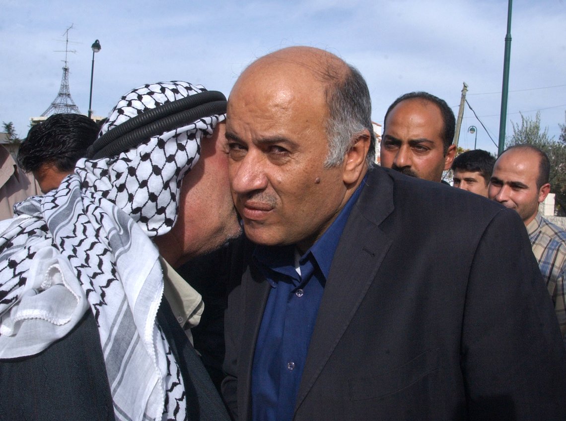 Palestinian security advisor Jibril Rajub, center, is kissed by a supporter after preliminary results showed he was leading in the Fatah Party primaries in the West Bank city of Hebron Saturday Dec. 3, 2005. The gruff security chief known for his pragmatic dealings with Israel was the top vote getter in primaries of the ruling Fatah Party in Hebron, according to preliminary results released Saturday, capping a rocky week of voting throughout the West Bank and Gaza Strip. (AP Photo/Nasser Shiyoukhi) Palestinian security advisor Jibril Rajub, center, is kissed by a supporter after preliminary results showed he was leading in the Fatah Party primaries in the West Bank city of Hebron Saturday Dec. 3, 2005. The gruff security chief known for his pragmatic dealings with Israel was the top vote getter in primaries of the ruling Fatah Party in Hebron, according to preliminary results released Saturday, capping a rocky week of voting throughout the West Bank and Gaza Strip. (AP Photo/Nasser Shiyoukhi)