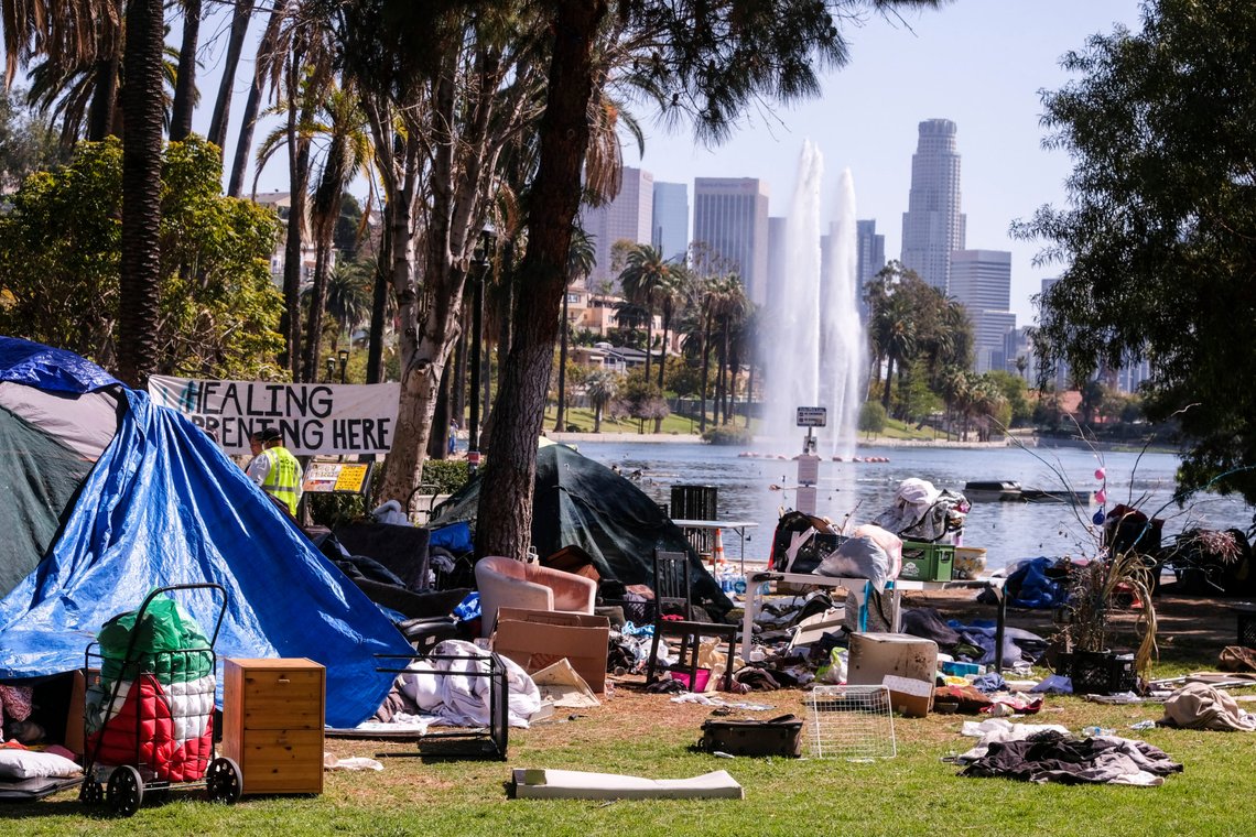 Workers remove debris around tents at a homeless encampment on the Echo Park Lake before their removal in Los Angeles Friday, March 26, 2021. Photo: Shutterstock by Ringo Chiu, USA. Workers remove debris around tents at a homeless encampment on the Echo Park Lake before their removal in Los Angeles Friday, March 26, 2021. Photo: Shutterstock by Ringo Chiu, USA.