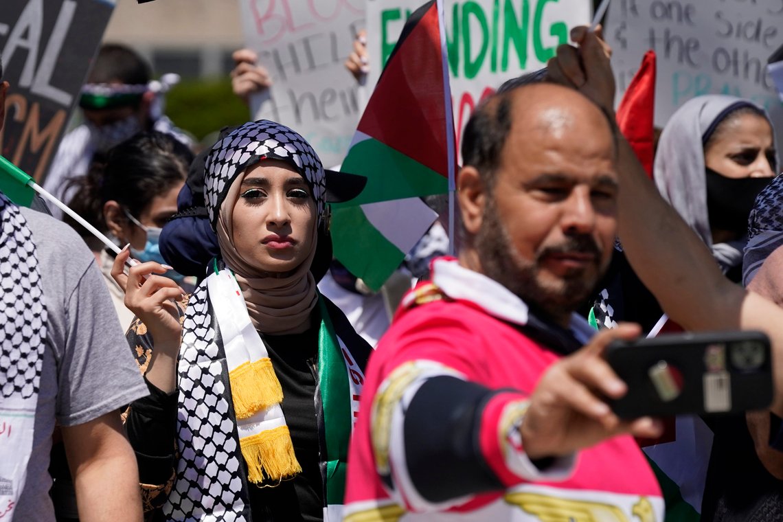 Protesters supporting Palestinians hold a rally, as President Joe Biden visits a Ford electric vehicle center nearby, Tuesday, May 18, 2021, in Dearborn, Mich. Biden’s efforts to spotlight his big infrastructure plans are suddenly being overshadowed by the escalating violence between Israel and the Palestinians. (AP Photo/Carlos Osorio) Protesters supporting Palestinians hold a rally, as President Joe Biden visits a Ford electric vehicle center nearby, Tuesday, May 18, 2021, in Dearborn, Mich. Biden’s efforts to spotlight his big infrastructure plans are suddenly being overshadowed by the escalating violence between Israel and the Palestinians. (AP Photo/Carlos Osorio)