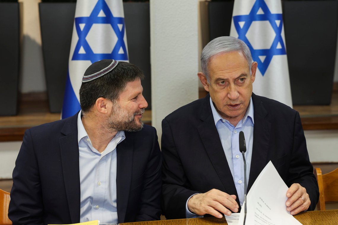 Israeli Prime Minister Benjamin Netanyahu, right, speaks with Minister of Finance Bezalel Smotrich during the weekly cabinet meeting at the Defence Ministry in Tel Aviv, Israel, Sunday Jan. 7, 2024. (Ronen Zvulun/Pool via AP) Israeli Prime Minister Benjamin Netanyahu, right, speaks with Minister of Finance Bezalel Smotrich during the weekly cabinet meeting at the Defence Ministry in Tel Aviv, Israel, Sunday Jan. 7, 2024. (Ronen Zvulun/Pool via AP)