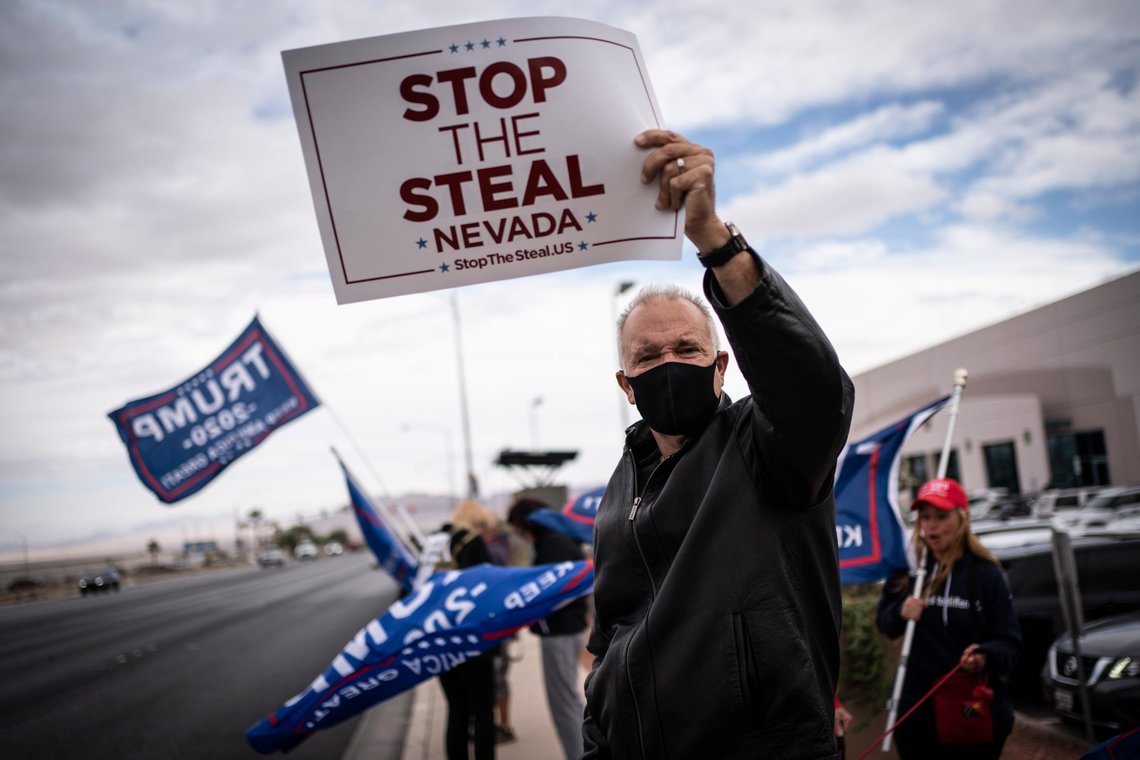 FILE - Supporters of President Donald Trump hold signs as they stand outside of the Clark County Elections Department in North Las Vegas, Nov. 7, 2020. According to a bipartisan report released Tuesday, Feb. 6, 2024, that calls for greater transparency and steps to make voting easier, a “tumultuous period of domestic unrest” combined with a complicated and highly decentralized election system has led to a loss of faith in election results among some in the U.S. (AP Photo/Wong Maye-E, File) FILE - Supporters of President Donald Trump hold signs as they stand outside of the Clark County Elections Department in North Las Vegas, Nov. 7, 2020. According to a bipartisan report released Tuesday, Feb. 6, 2024, that calls for greater transparency and steps to make voting easier, a “tumultuous period of domestic unrest” combined with a complicated and highly decentralized election system has led to a loss of faith in election results among some in the U.S. (AP Photo/Wong Maye-E, File)