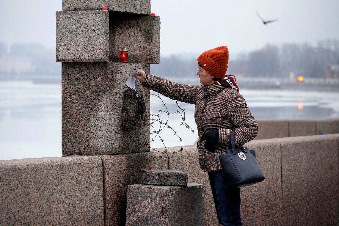 A woman places a piece of paper with words of grief for Alexei Navalny paying the last respect to him at the Memorial to Victims of Political Repression in St. Petersburg, Russia, Saturday, Feb. 24, 2024. Navalny, 47, Russia's most well-known opposition politician, unexpectedly died on Feb. 16 in the penal colony, prompting hundreds of Russians across the country to stream to impromptu memorials with flowers and candles. (AP Photo/Dmitri Lovetsky) A woman places a piece of paper with words of grief for Alexei Navalny paying the last respect to him at the Memorial to Victims of Political Repression in St. Petersburg, Russia, Saturday, Feb. 24, 2024. Navalny, 47, Russia's most well-known opposition politician, unexpectedly died on Feb. 16 in the penal colony, prompting hundreds of Russians across the country to stream to impromptu memorials with flowers and candles. (AP Photo/Dmitri Lovetsky)