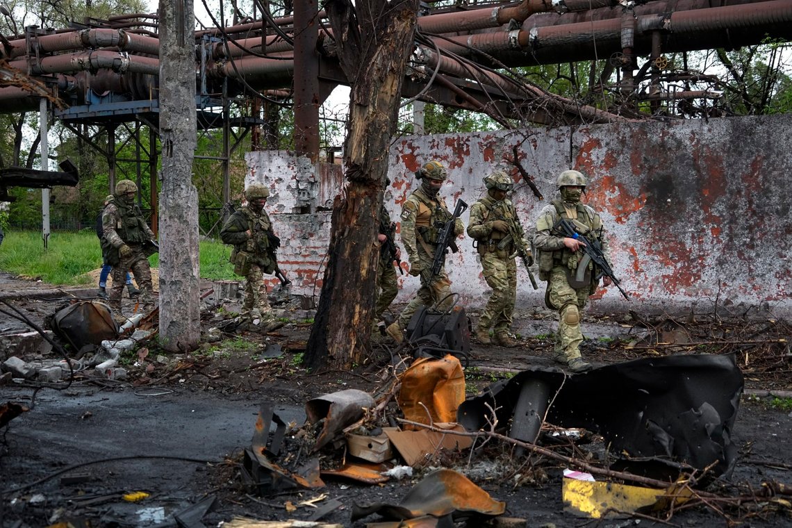 FILE - Russian troops walk in a destroyed part of the Illich Iron & Steel Works Metallurgical Plant in Mariupol, in territory under the government of the Donetsk People's Republic, eastern Ukraine, on May 18, 2022. (AP Photo, File) FILE - Russian troops walk in a destroyed part of the Illich Iron & Steel Works Metallurgical Plant in Mariupol, in territory under the government of the Donetsk People's Republic, eastern Ukraine, on May 18, 2022. (AP Photo, File)