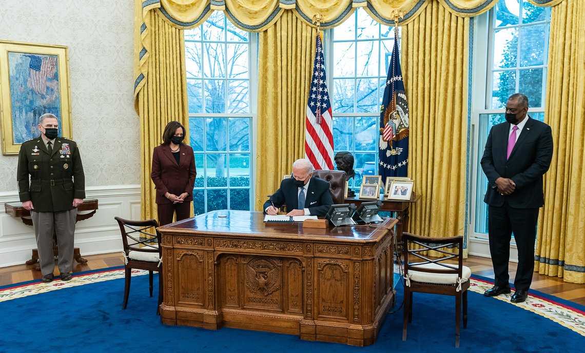 President Joe Biden, joined by Vice President Kamala Harris, Secretary of Defense Llyod Austin (right) and Chairman of the Joint Chiefs Mark Milley (left), sign an executive order rescinding a band on transgender individuals serving in the military Monday, Jan. 25, 2021, in the Oval Office of the White House. (Official White House Photo by Adam Schultz). Photo: Wikimedia Commons. President Joe Biden, joined by Vice President Kamala Harris, Secretary of Defense Llyod Austin (right) and Chairman of the Joint Chiefs Mark Milley (left), sign an executive order rescinding a band on transgender individuals serving in the military Monday, Jan. 25, 2021, in the Oval Office of the White House. (Official White House Photo by Adam Schultz). Photo: Wikimedia Commons.