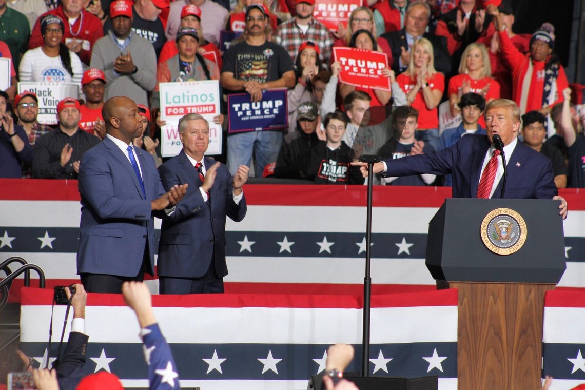 North Charleston, SC - February 28, 2020 President Trump (r) brings up South Carolina repulican senators Tim Scott (l) and Lindsey Graham (c) to be acknowledged during his rally in South Carolina. Photo: Shutterstock by Positiveimages. North Charleston, SC - February 28, 2020 President Trump (r) brings up South Carolina repulican senators Tim Scott (l) and Lindsey Graham (c) to be acknowledged during his rally in South Carolina. Photo: Shutterstock by Positiveimages.