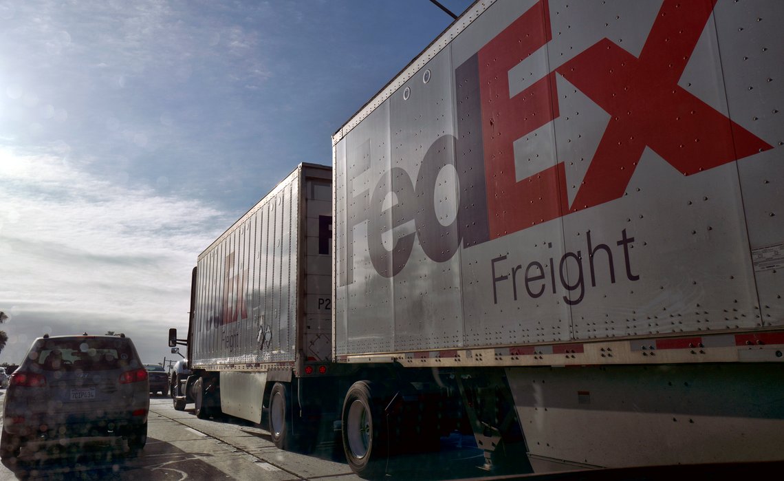 FILE - In this May 1, 2019 photo, a Fed-Ex tractor trailer truck makes it's way along the Hollywood Freeway in Los Angeles. California regulators on Tuesday, April 28, 2020, strengthened a proposed first-in-the-nation rule that would force auto makers to sell more electric delivery vans and work trucks in a state with the country's worst air quality. (AP Photo/Richard Vogel, File) FILE - In this May 1, 2019 photo, a Fed-Ex tractor trailer truck makes it's way along the Hollywood Freeway in Los Angeles. California regulators on Tuesday, April 28, 2020, strengthened a proposed first-in-the-nation rule that would force auto makers to sell more electric delivery vans and work trucks in a state with the country's worst air quality. (AP Photo/Richard Vogel, File)