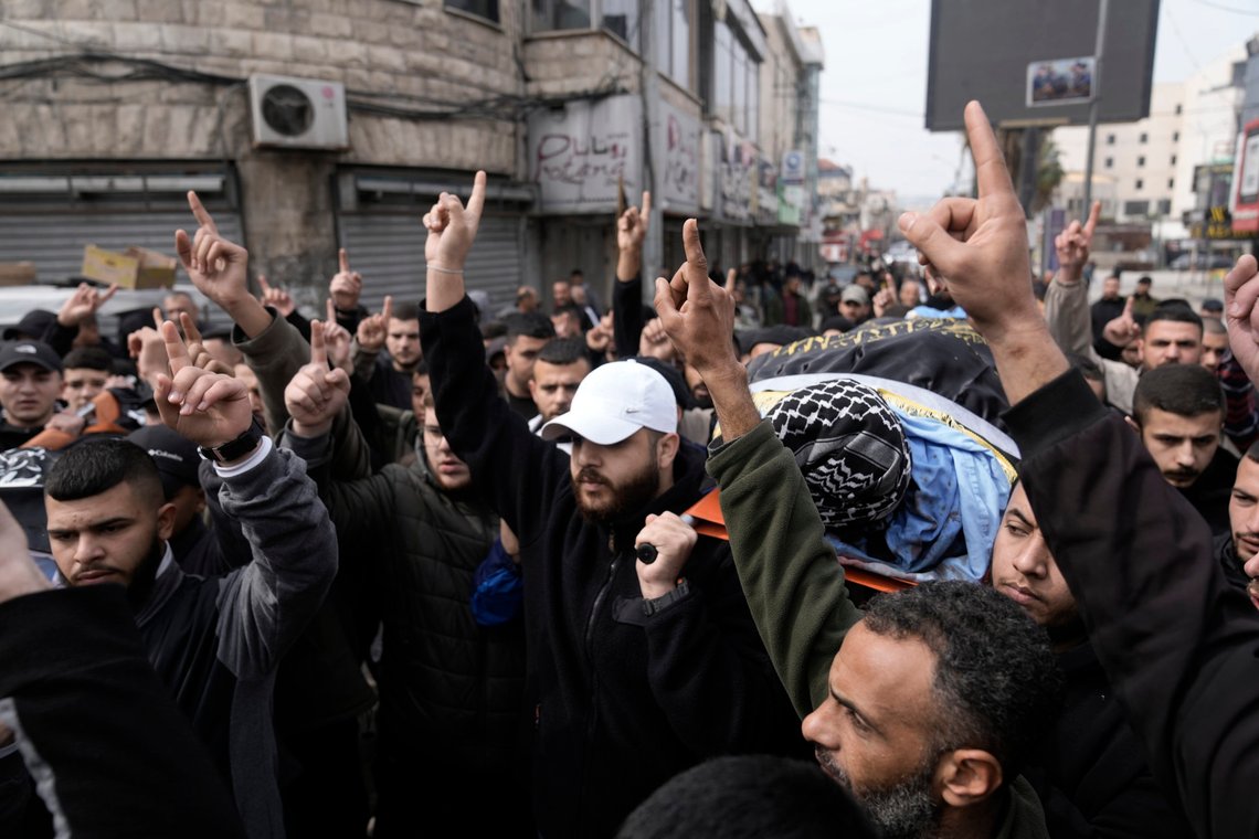 Gunmen carry the bodies of Said Jaradat, left, and Yasser Hanoun, both draped in the flag of the Islamic Jihad militant group, on Friday, Feb. 23, 2024. The pair were killed in an Israeli drone strike on a car in the West Bank Jenin refugee camp a day earlier. The Israeli military alleged that Hanoun was previously involved in several shooting attacks targeting Israeli settlements and army posts. (AP Photo/Majdi Mohammed) Gunmen carry the bodies of Said Jaradat, left, and Yasser Hanoun, both draped in the flag of the Islamic Jihad militant group, on Friday, Feb. 23, 2024. The pair were killed in an Israeli drone strike on a car in the West Bank Jenin refugee camp a day earlier. The Israeli military alleged that Hanoun was previously involved in several shooting attacks targeting Israeli settlements and army posts. (AP Photo/Majdi Mohammed)