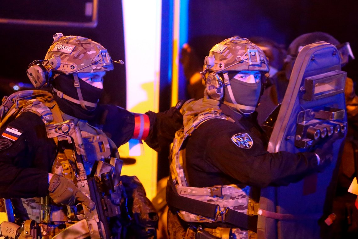 Russian Rosguardia (National Guard) servicemen walk toward the Crocus City Hall on the western edge of Moscow, Russia, Friday, March 22, 2024. Several gunmen have burst into a big concert hall in Moscow and fired automatic weapons at the crowd, injuring an unspecified number of people and setting a massive blaze in an apparent terror attack days after President Vladimir Putin cemented his grip on the country in a highly orchestrated electoral landslide. (Sergei Vedyashkin/Moscow News Agency via AP) Russian Rosguardia (National Guard) servicemen walk toward the Crocus City Hall on the western edge of Moscow, Russia, Friday, March 22, 2024. Several gunmen have burst into a big concert hall in Moscow and fired automatic weapons at the crowd, injuring an unspecified number of people and setting a massive blaze in an apparent terror attack days after President Vladimir Putin cemented his grip on the country in a highly orchestrated electoral landslide. (Sergei Vedyashkin/Moscow News Agency via AP)