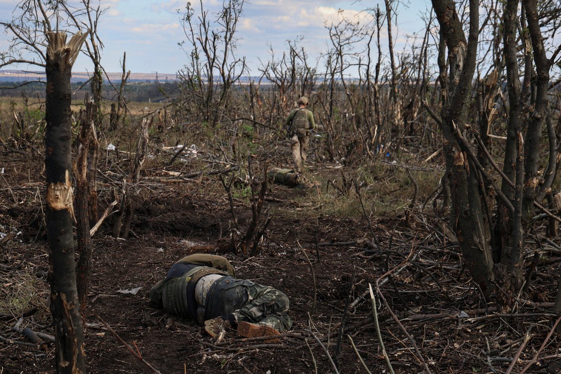 Assault unit commander from 3rd Assault Brigade, who goes by the call sign 'Fedia,' passes by the bodies of dead Russian soldiers at the frontline on a way to Andriivka, Donetsk region, Ukraine, Saturday, Sept. 16, 2023. The brigade announced Friday they had recaptured the war-ravaged settlement which lies 10 kilometers (6 miles) south of Russian-occupied city of Bakhmut, in the country's embattled east. (AP Photo/Alex Babenko) Assault unit commander from 3rd Assault Brigade, who goes by the call sign 'Fedia,' passes by the bodies of dead Russian soldiers at the frontline on a way to Andriivka, Donetsk region, Ukraine, Saturday, Sept. 16, 2023. The brigade announced Friday they had recaptured the war-ravaged settlement which lies 10 kilometers (6 miles) south of Russian-occupied city of Bakhmut, in the country's embattled east. (AP Photo/Alex Babenko)