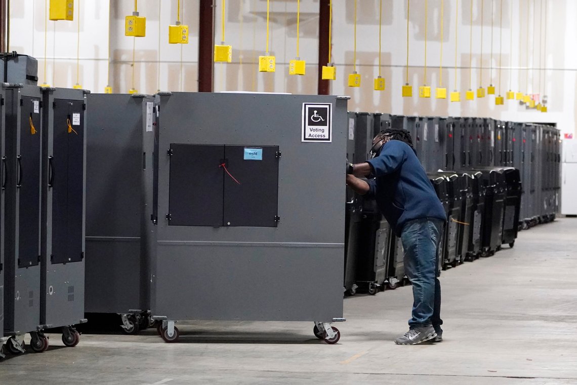 FILE - A worker returns voting machines to storage at the Fulton County Election preparation Center Wednesday, Nov. 4, 2020 in Atlanta, Ga. In an advisory sent to state election officials, and obtained by The Associated Press in advance of its expected on Friday, June 3, 2022, the nation’s leading cybersecurity agency says that electronic voting machines from a leading vendor used in at least 16 states have software vulnerabilities. The U.S. Cybersecurity and Infrastructure Agency, or CISA, said there is no evidence the flaws in the Dominion Voting Systems’ equipment have been exploited to alter election results. (AP Photo/John Bazemore, File) FILE - A worker returns voting machines to storage at the Fulton County Election preparation Center Wednesday, Nov. 4, 2020 in Atlanta, Ga. In an advisory sent to state election officials, and obtained by The Associated Press in advance of its expected on Friday, June 3, 2022, the nation’s leading cybersecurity agency says that electronic voting machines from a leading vendor used in at least 16 states have software vulnerabilities. The U.S. Cybersecurity and Infrastructure Agency, or CISA, said there is no evidence the flaws in the Dominion Voting Systems’ equipment have been exploited to alter election results. (AP Photo/John Bazemore, File)